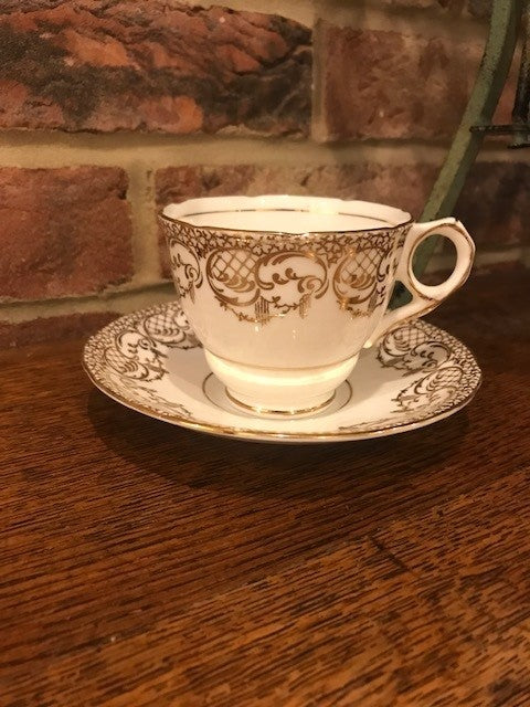 Pretty white and gold cup and saucer