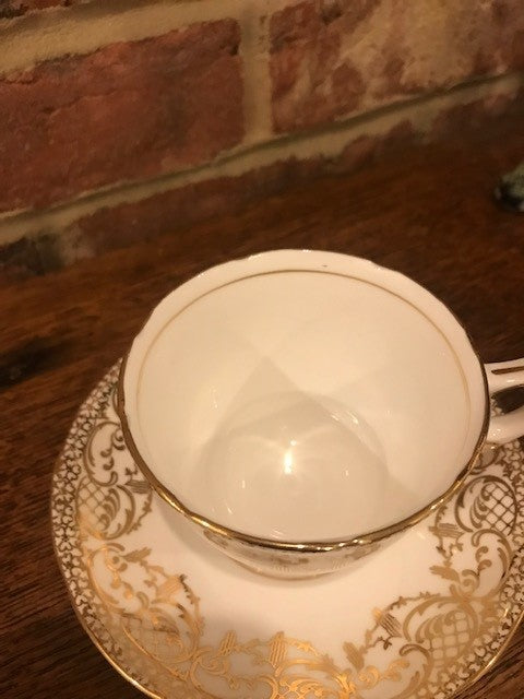 Pretty white and gold cup and saucer