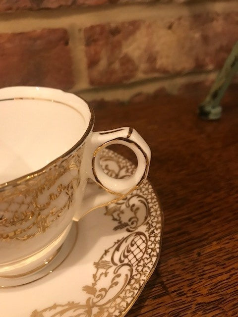 Pretty white and gold cup and saucer