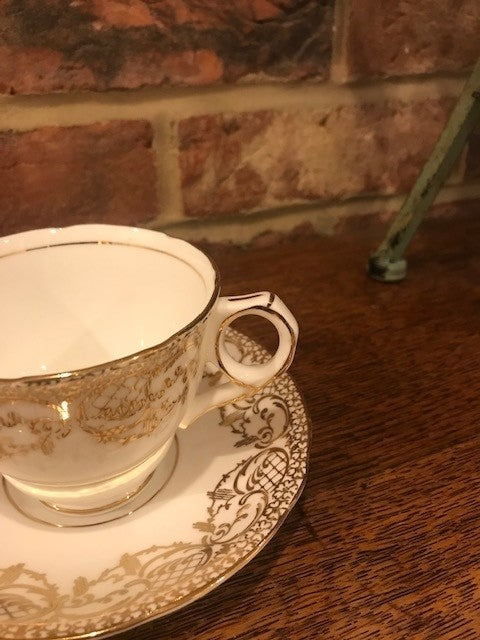 Pretty white and gold cup and saucer